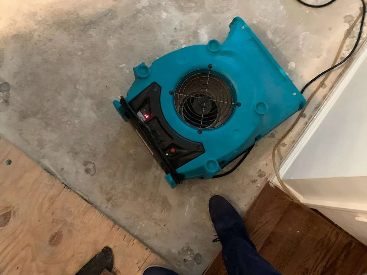 Air mover drying subfloor during Leak Detection & Repair in Sharon